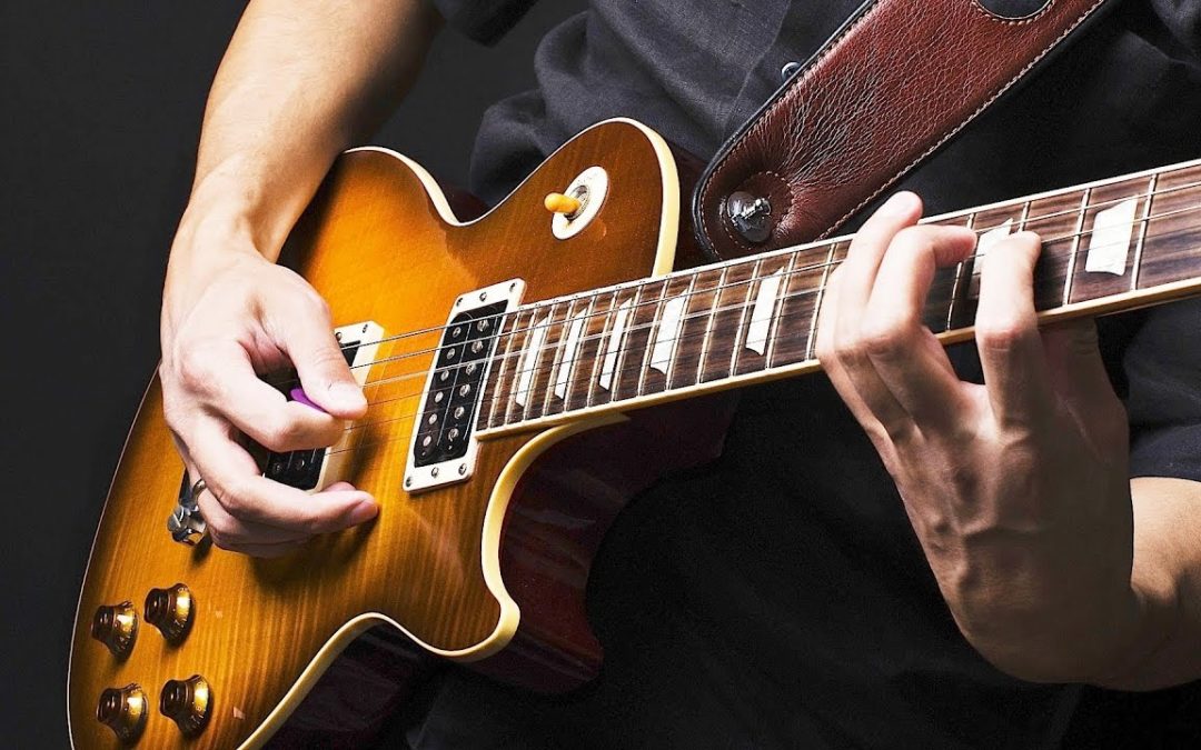 How To Hold A Guitar Pick Properly (For Strumming & Speed)